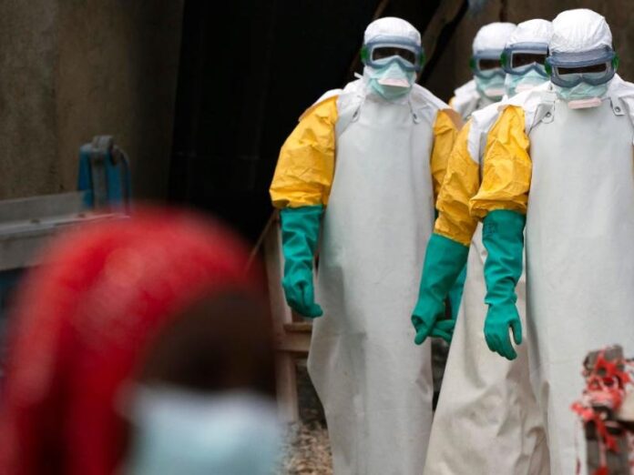 Medical workers in protective gear treating Ebola patients in eastern DRC