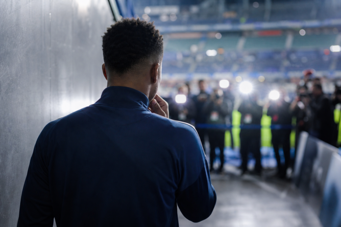 Silhouette d un footballeur dans un tunnel de stade sous les flashs
