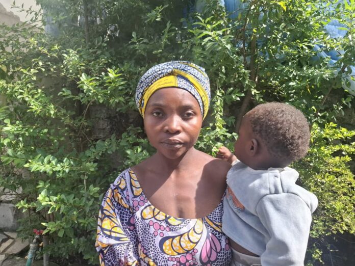 Familles déposant des fleurs sur des tombes ornées dans un cimetière congolais lors de la journée nationale des parents