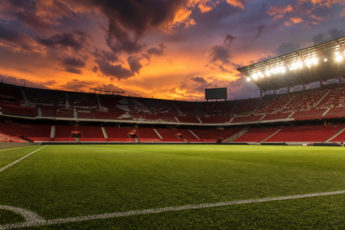 Illustration editoriale d un stade andalou au coucher du soleil apres la victoire 1-0 du Betis contre la Real Sociedad.