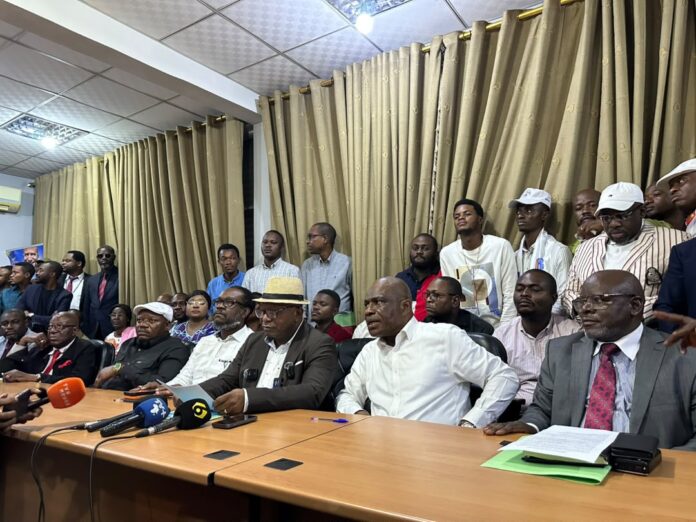 Membres de l'opposition lors d'une réunion politique à Kinshasa, illustrant les tensions politiques