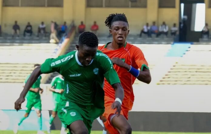 Stade de football avec des joueurs en maillots vert blanc et orange lors d'un match de Ligue II