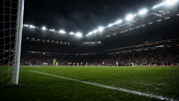 Illustration editoriale neutre d un stade anglais de nuit apres le nul 2-2 entre Newcastle et Liverpool, avec une atmosphere de fin de match dramatique.