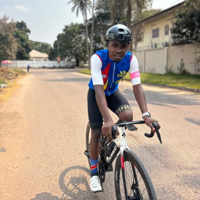 Vélo de gravel et sac de voyage dans une cour poussiéreuse de Goma, évoquant le forfait de Joël Kyaviro