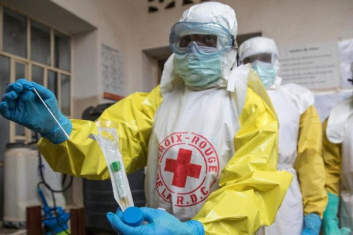 Tenue de protection et matériel de désinfection devant un centre de santé au Nord-Kivu
